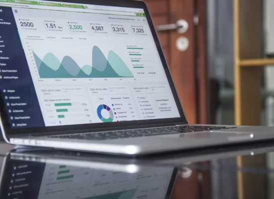 Marketer checking Google Ads campaign performance and cost on a laptop
